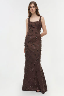 Brown sleeveless gown with scattered beaded and sequined embellishments throughout, fitted silhouette, floor-length.