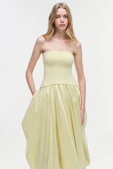 Pale yellow strapless midi dress with fitted bodice and pleated skirt, featuring side pockets.