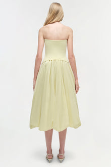 Pale yellow strapless midi dress with fitted bodice and full gathered skirt, shown from back.