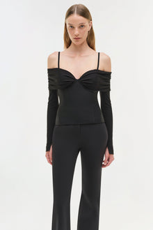 Black off-shoulder top with long sleeves, twisted neckline detail, and thin shoulder straps.