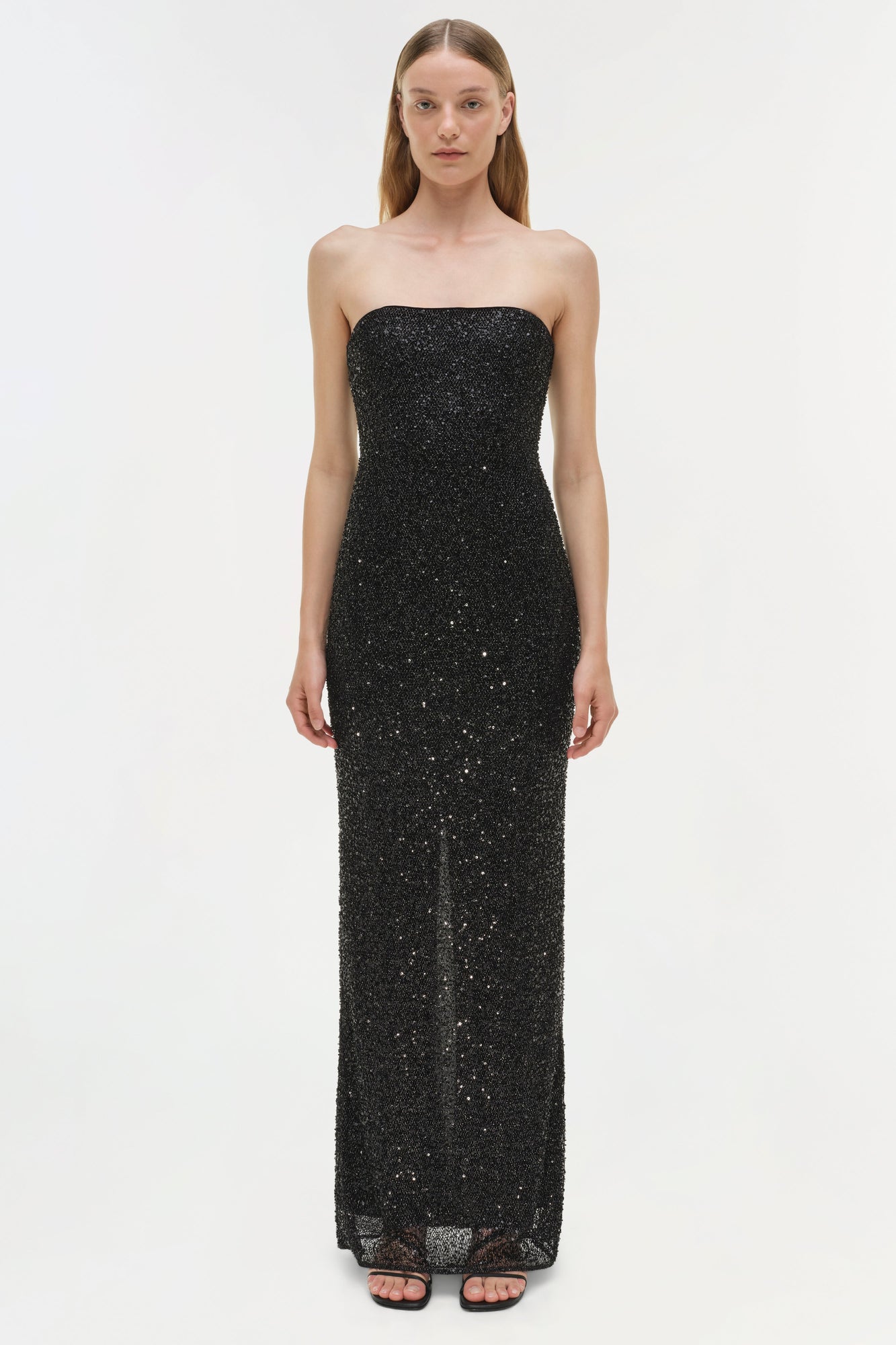 Black sequin strapless gown with fitted bodice and floor-length skirt.