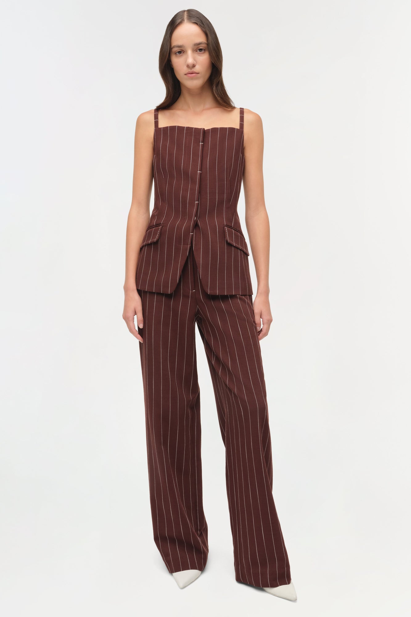 Burgundy pinstriped sleeveless top with square neckline, button front, and flap pockets paired with matching wide-leg trouser