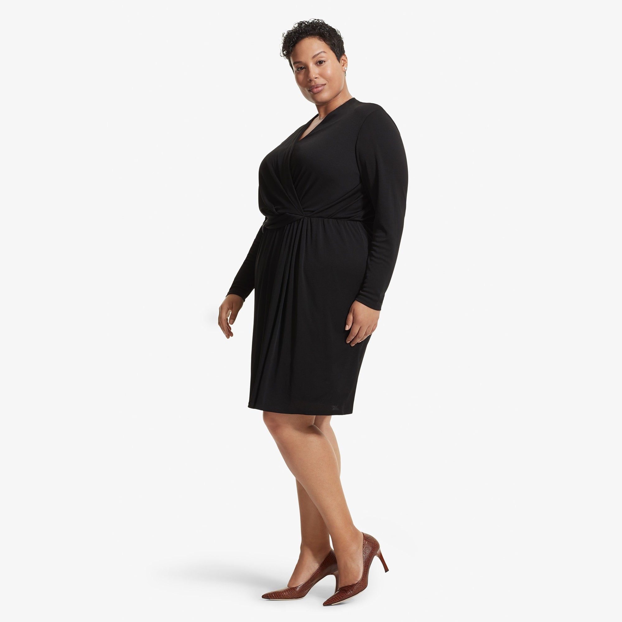 Side image of a woman standing wearing the Morgan dress in Black | Exclude