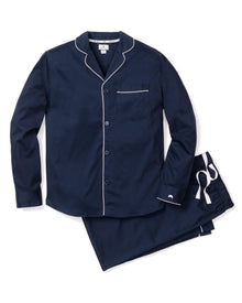 The Petite Plume Mens Twill Pajamas in Navy, featuring elegant white piping, include a long-sleeved button-up top with a chest pocket and matching drawstring pants—perfect for stylish sleepwear.
