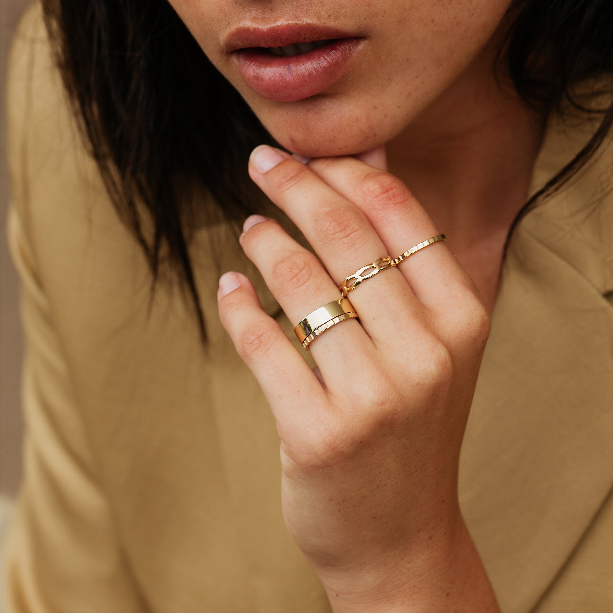 Model. Close up of woman's hand with various rings.