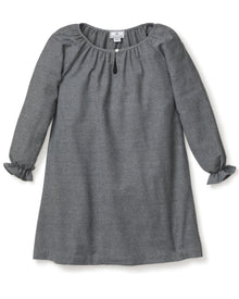 The Girls Flannel Delphine Nightgown in Grey by Petite Plume is a gray, long-sleeved nightgown with a round neckline and front keyhole detail. It features ruffled cuffs and subtly textured brushed cotton flannel, making it perfect for cozy nights as chemical-free sleepwear.