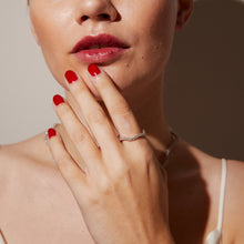 Close up of woman wearing gemstone ring
