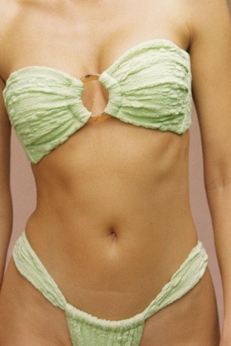 Light green textured bandeau bikini top with bow-tie center detail and matching bottoms.