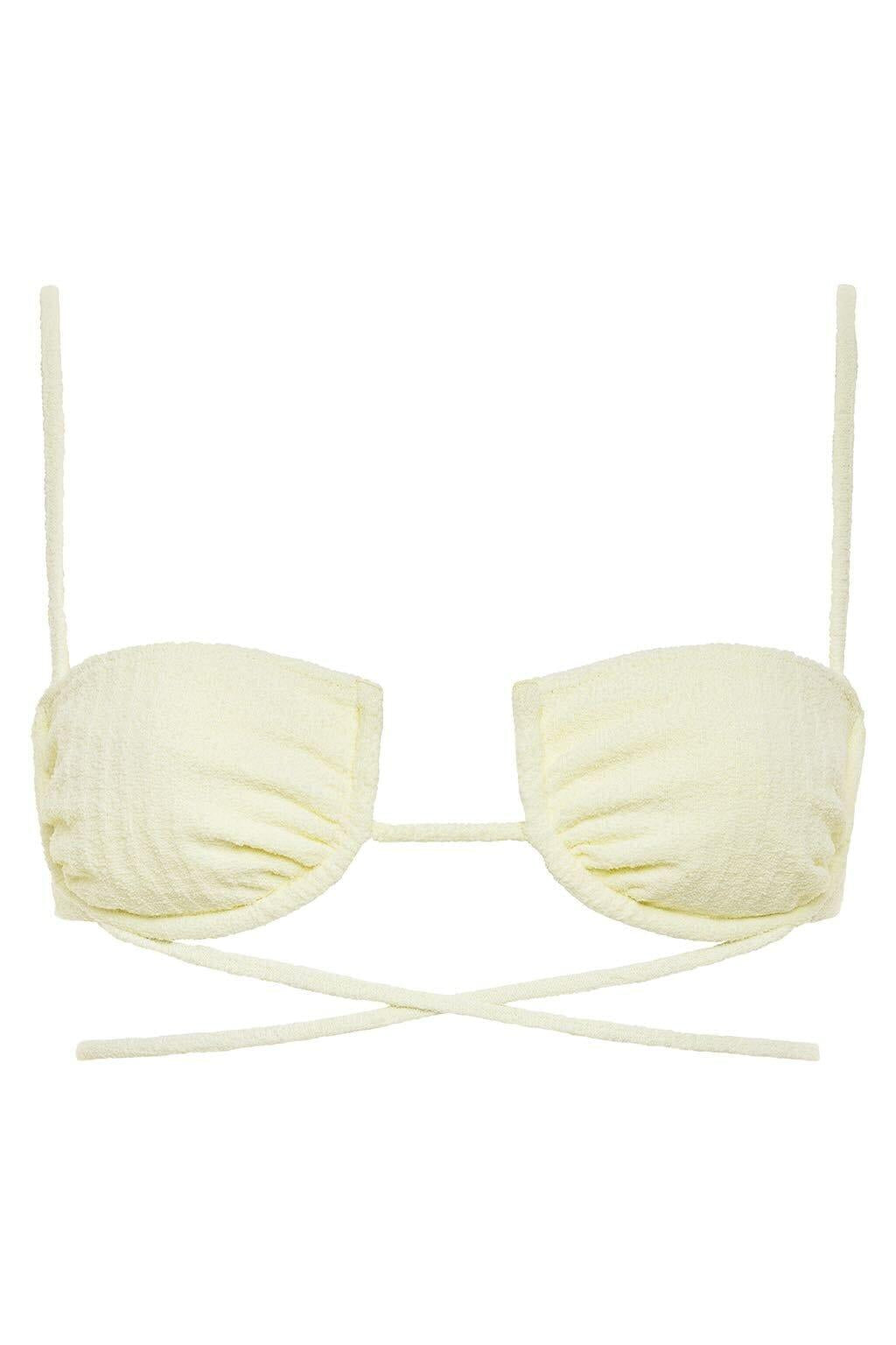 Cream-colored ribbed bikini top with underwire cups, thin shoulder straps, and cross-back tie closure.