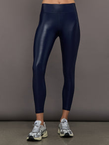 Model wears liquid takara shine leggings in regular rise with a thick waistband in navy.