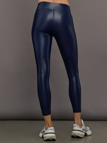 Model wears liquid takara shine leggings in regular rise with a thick waistband in navy.