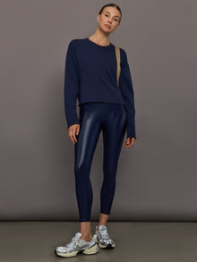 Model wears liquid takara shine leggings in regular rise with a thick waistband in navy.