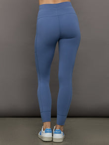 Model wears a periwinkle blue buttery soft pair of leggings with pockets and drawstring waist, perfect for all activities. 