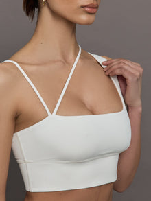 Close-up of the Asymmetrical Strappy Bra in Diamond Compression Cloud Dancer highlighting the strap detail and square neckline.