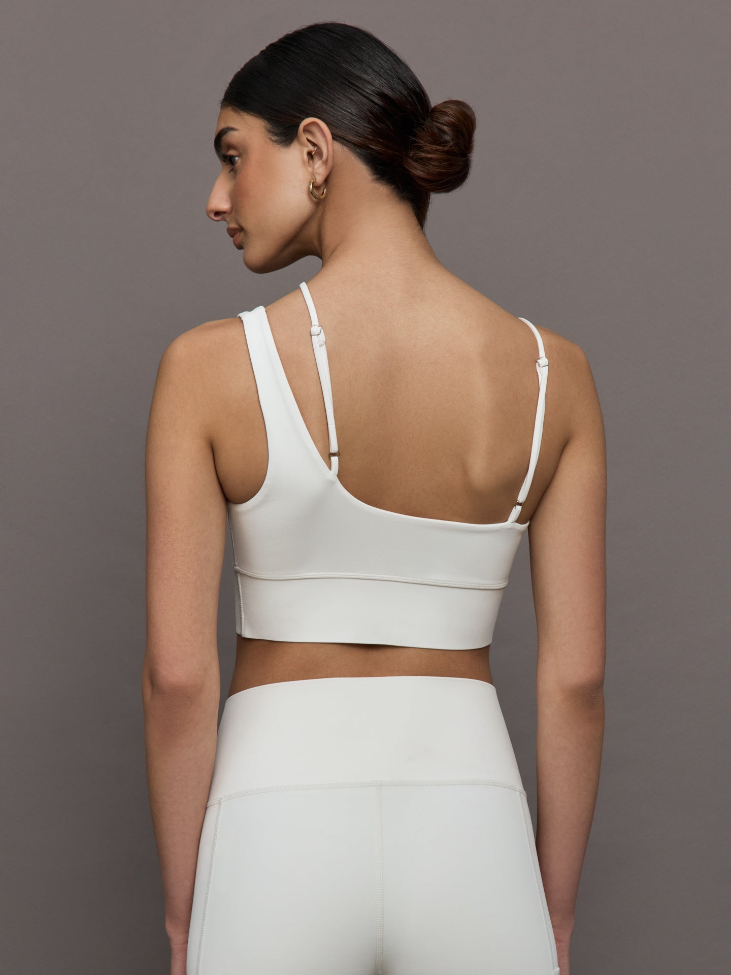 Back view of the Asymmetrical Strappy Bra in Diamond Compression Cloud Dancer with adjustable straps and bonded band.