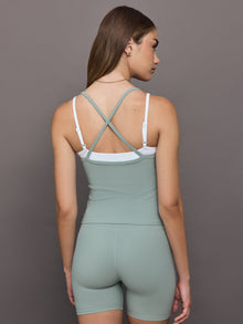Model wears double-layered melt tank with sage outer body and white inner layer.