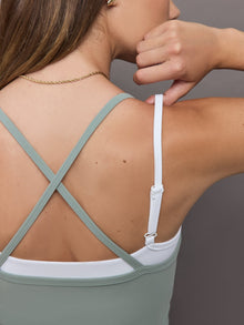 Model wears double-layered melt tank with sage outer body and white inner layer.