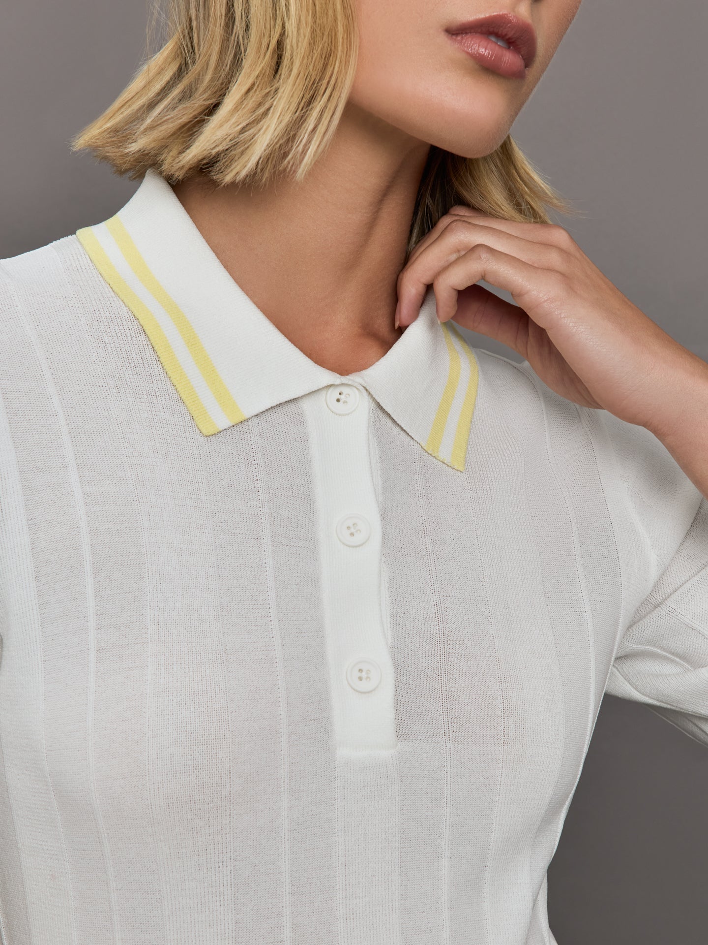 Model wears a lightweight and breathable polo tee shirt with yellow collar and sleeve details. 
