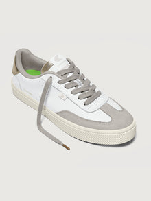 White and off-white colored sneakers with leather and suede materials, featuring a low-top design and lace-up closure.