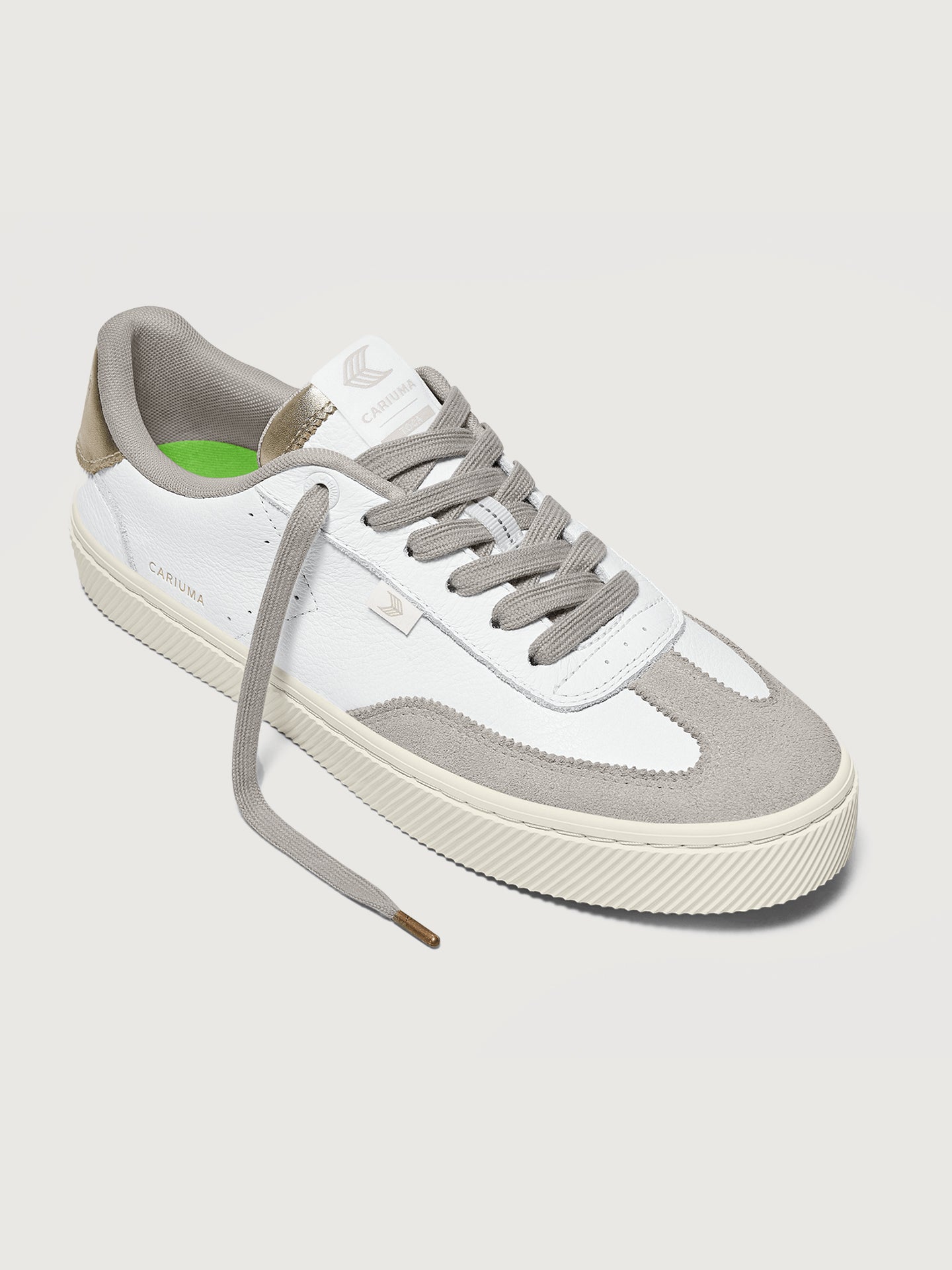 White and off-white colored sneakers with leather and suede materials, featuring a low-top design and lace-up closure.
