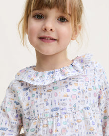 The Kid's Twill Scarlett Nightgown in Baking Spirits Bright features long sleeves, a ruffled collar and cuffs, and a pastel cupcake, teapot, and cutlery print on a white background.