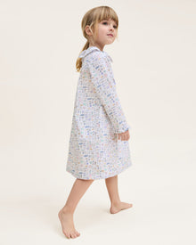 The Kid's Twill Scarlett Nightgown in Baking Spirits Bright features long sleeves, a ruffled collar and cuffs, and a pastel cupcake, teapot, and cutlery print on a white background.
