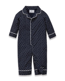 The Baby's Twill Classic Romper in Midnight Hearts is a navy blue onesie with long sleeves and legs, featuring a white heart pattern and white piping on the collar, cuffs, and front.