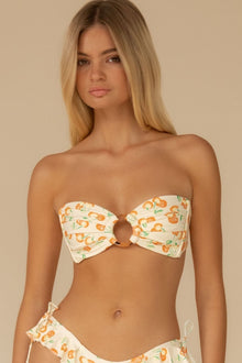 Cream bandeau bikini top with orange cherry print and center ring detail.