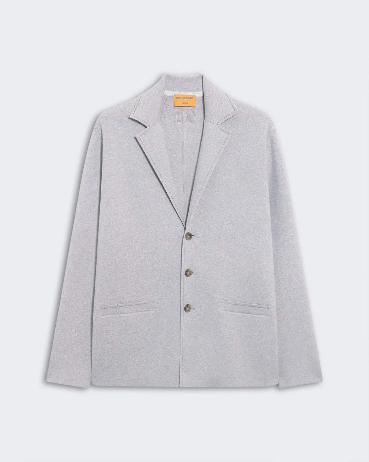 Off Duty Blazer - Stone, a soft light grey blazer with a relaxed fit featuring notch lapels, three front buttons, and two welt pockets, displayed flat on a neutral background.