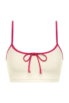 Cream racerback sport top with raspberry binding and adjustable drawstring tie at center front.