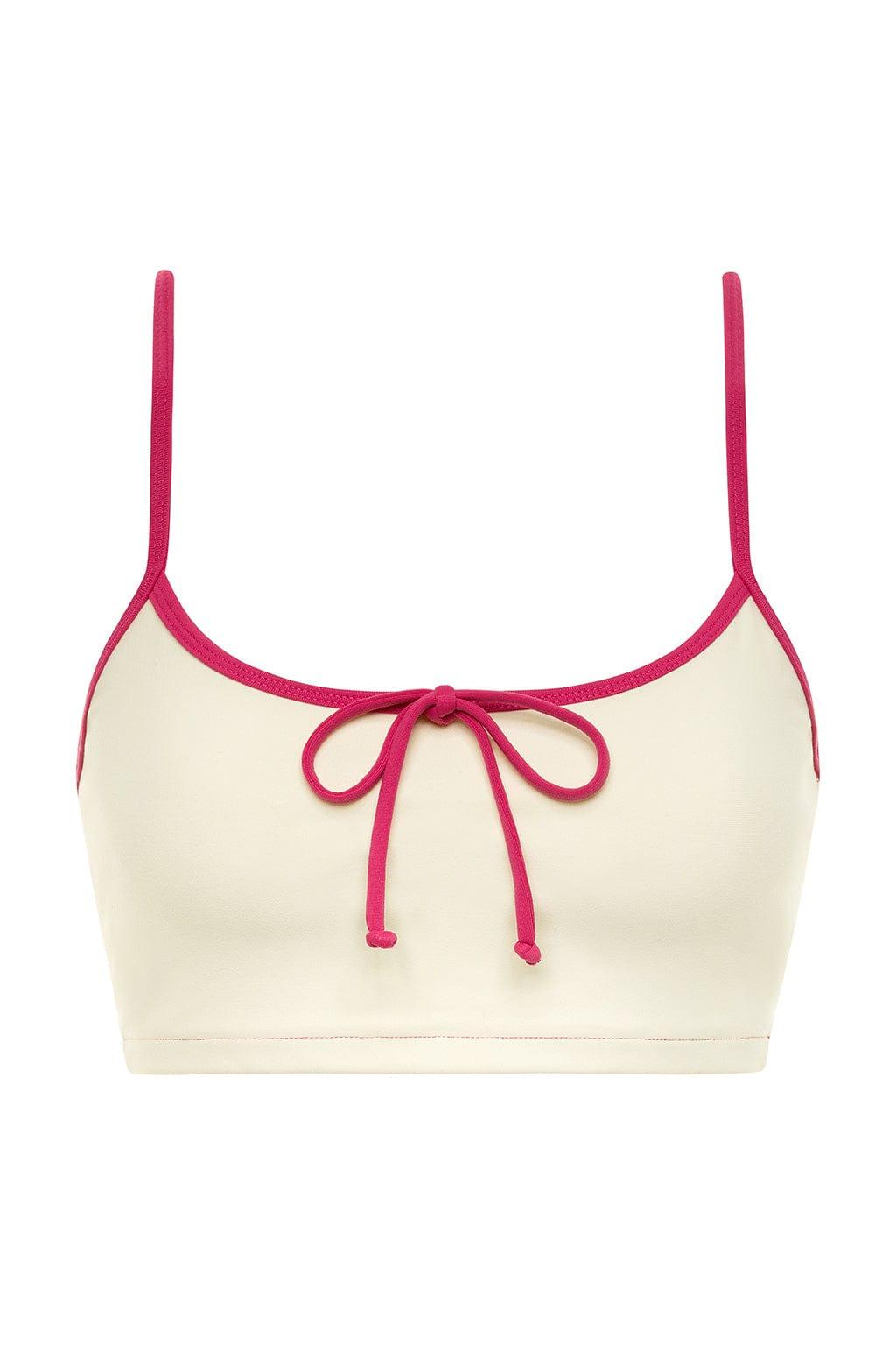 Cream racerback sport top with raspberry binding and adjustable drawstring tie at center front.