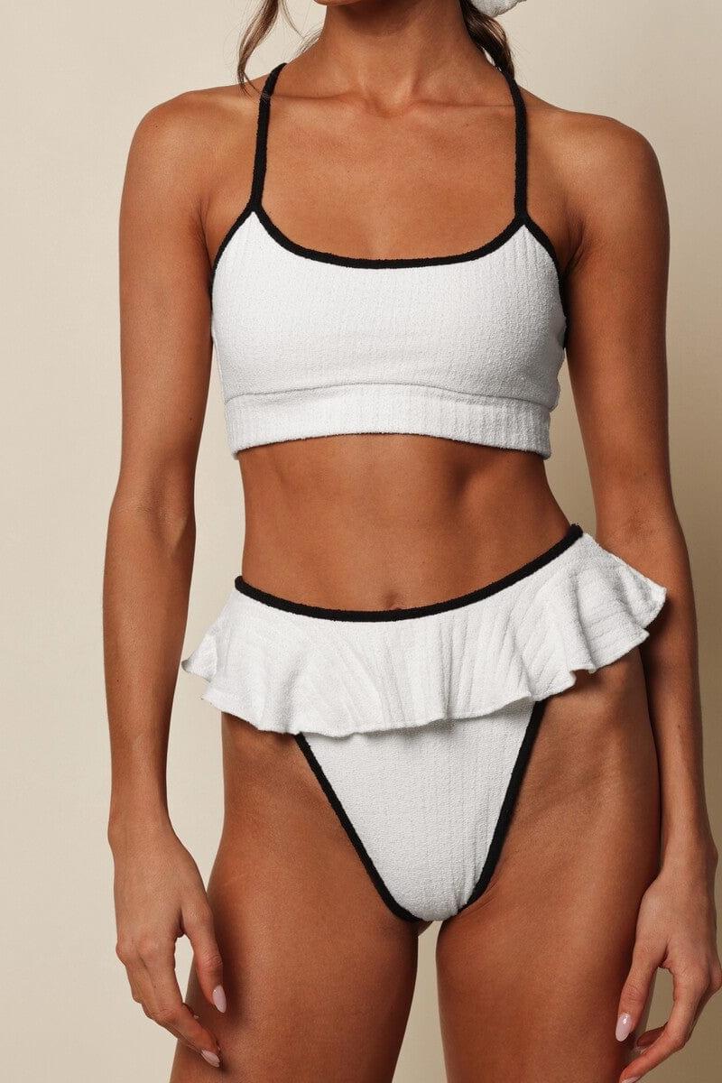 Cream bikini bottom with black binding and ruffled front detail on lower body.