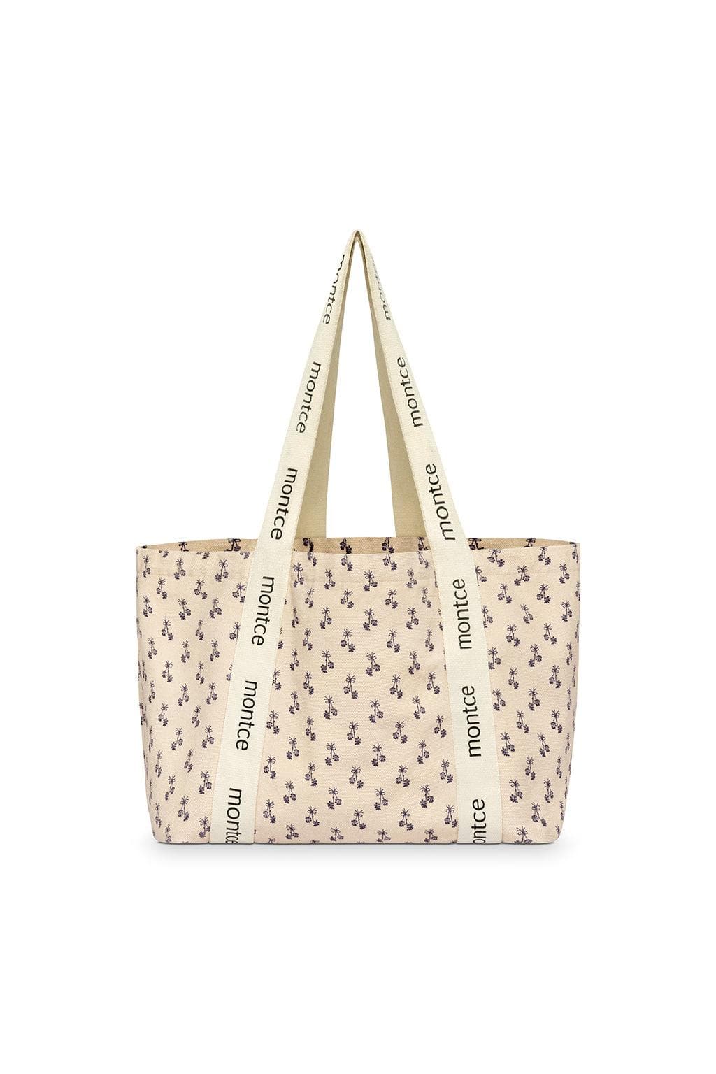 Cream tote bag with small purple floral print and "montce" text on handles.