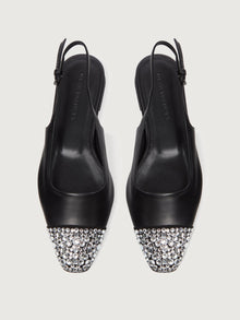 Black leather slingback flat with a sharp square-toe and crystals on the cap.