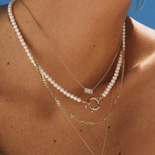 Lifestyle Model. Close up of a woman wearing stacked necklaces