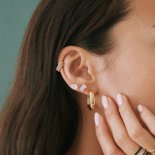 Lifestyle Model side profile of woman wearing various earrings