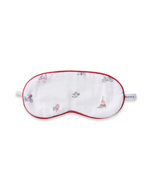 The Kids Coastal Charms Eye Mask by Petite Plume is a white sleep mask with red trim, adorned with illustrations of a bicycle, sailboat, folding chair, and rower. A PETITE tag on the side makes it perfect for personalization and gifting to those who love custom touches.