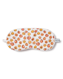 Petite Plumes Kids Twill Sleep Mask in Pumpkin Patch features a festive white design with orange pumpkins and carved faces. A PETITE tab adds charm, making it a delightful Halloween print for matching eye masks.