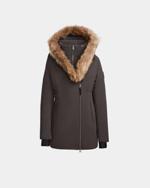 The Rudsak AURORE - L123561 Grey is a womens down parka featuring an asymmetrical front zipper and a large hood with brown faux fur trim, shown against a plain white background.