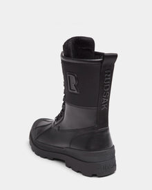 The DAMIEN - M222500 Black men’s winter boot by Rudsak features weather-treated leather, rugged sole, lace-up front, pull tab, insulation, embossed Rudsak branding on the heel and pull tab, and a large R logo on the side.