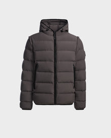 The Rudsak DEMIAN M-R - M123504 Grey is a dark gray men’s down puffer jacket with a hood, front zip closure, and side pockets, made from sustainable recycled fabric. Shown on a plain white background.