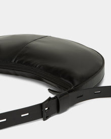 A close-up of the Rudsak LANISSA - 8324505 Black hobo bag, featuring a curved design, visible stitching, zipper closure, and an adjustable strap with rectangular holes—perfect as a chic womens crossbody accessory.