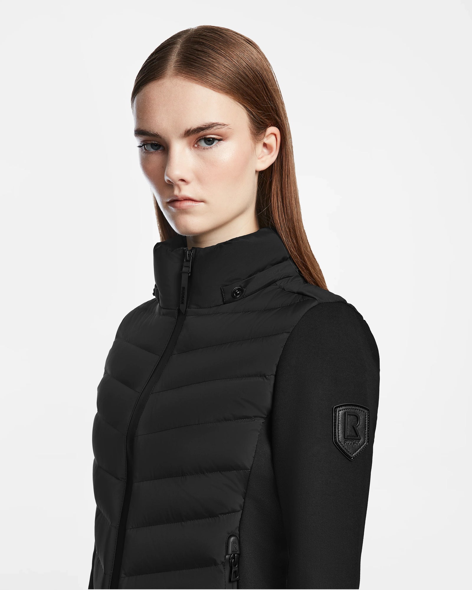 A woman in the Rudsak MALYA M - L123547 black activewear-inspired jacket.