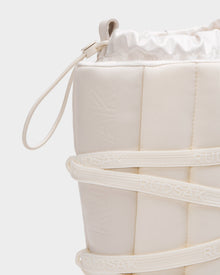 Close-up of the Rudsak RODIN - 8224502 Iceland women’s winter boot in white, featuring padded quilted material, wraparound laces, a top drawstring closure, anti-slip sole, and subtle branding.