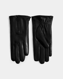 The AUGUSTA - L425546 Black women's lamb leather gloves by Rudsak are shown on a light background: one features a top zipper, while the other displays the palm with gathered wrist elastic—an essential for cold weather.