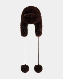 The Rudsak DEMI - L425539 Espresso is a dark brown women’s faux-fur aviator hat with ear flaps and two long strings topped with large fur pom-poms, shown against a plain light background.