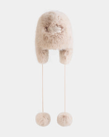 The Rudsak DEMI - L425539 Vanilla is a plush, light beige faux-fur aviator hat with ear flaps, long cords ending in fur pom-poms, and a signature front label—a cozy women's winter accessory for ultimate warmth.