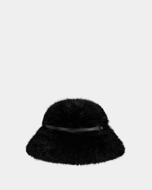 The YURI - L425538 Black by Rudsak is a women’s faux-fur bucket hat with a wide brim and thin vegan-leather trim, shown against a light gray background—the perfect winter accessory.