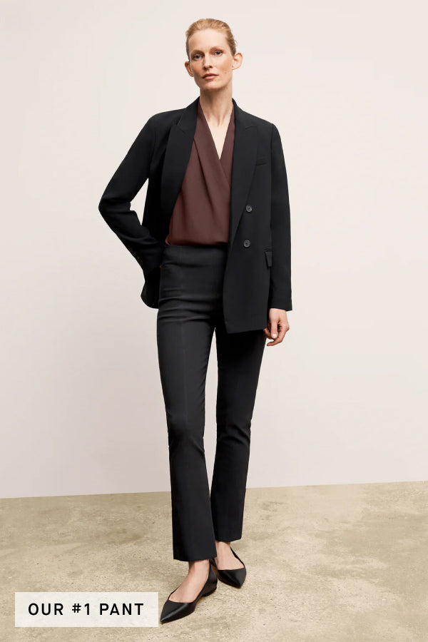 Front image of a woman standing wearing the Foster Pant—Everstretch in Black | Exclude
