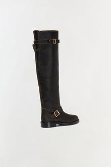 Black leather over-the-knee boot with gold buckle straps and contrasting stitching detail.